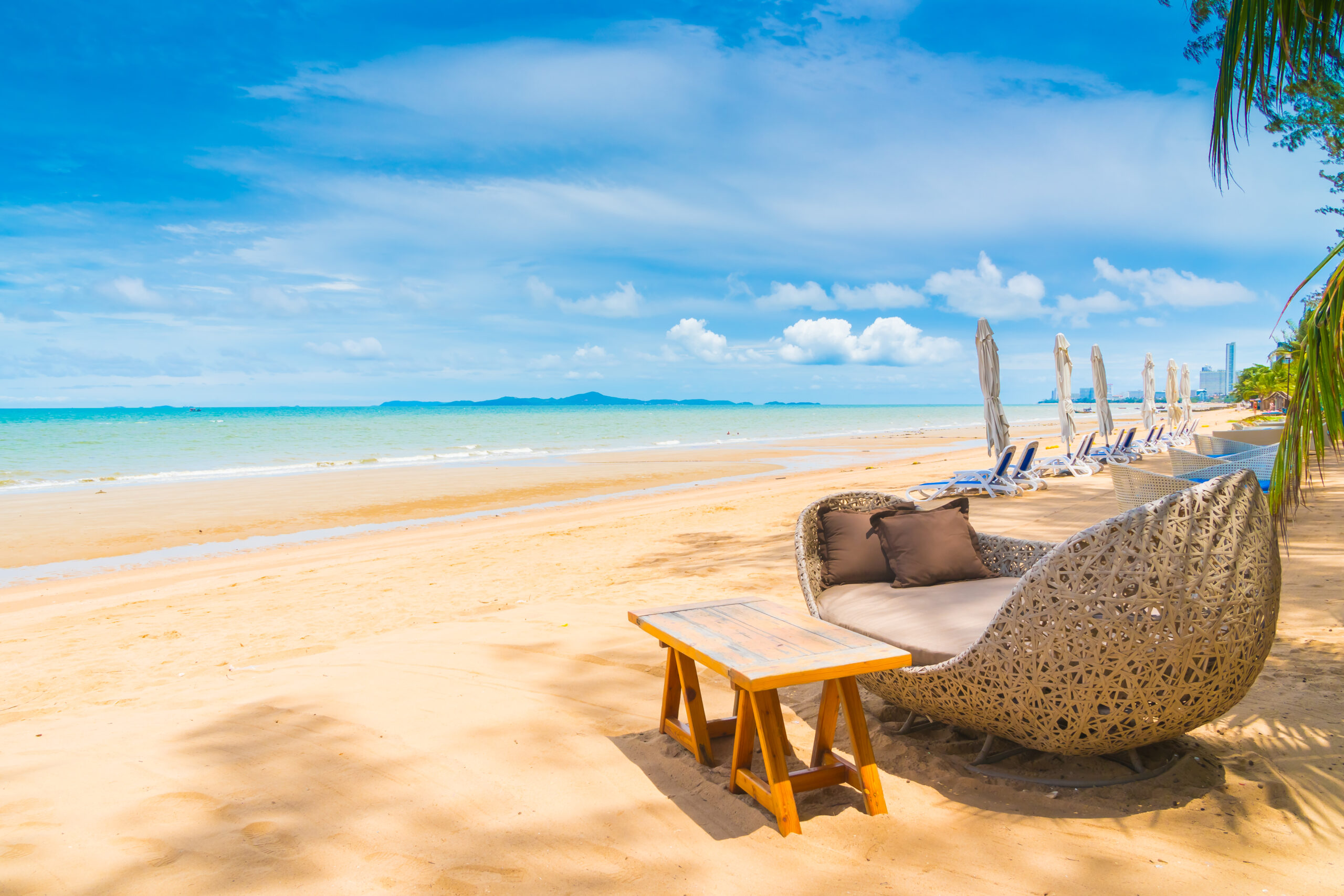 Chairs and umbrella overlooking clear waters at an exclusive luxury beach resort